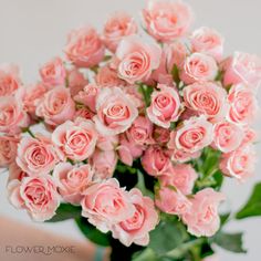 a vase filled with pink roses on top of a table