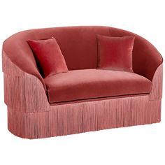 a red couch with fringe trim and pillows on it's back end, sitting in front of a white background