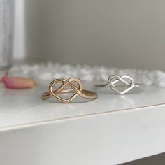 The sweetest little love knot to add to your ring collection, wear it in a fun stack or if you're a lover of all things minimalistic you'll rock it alone. Each and every ring is hand-made for you in our studio at the time of order in sterling silver or 14kt gold or rose gold-filled. Made to mix and match with other pieces from our collection. You're going to love creating your custom stack! This piece will ship from our studio in 1 to 2 weeks. * There may be a slight seam on gold filled or rose Modern Twist Twisted Jewelry Gift, Minimalist Twisted Jewelry For Anniversary, Modern Twist Infinity Stackable Rings As Gift, Adjustable Infinity Stackable Rings With A Modern Twist, Gift Sterling Silver Infinity Stackable Rings, Sterling Silver Infinity Stackable Rings As Gift, Adjustable Stackable Rings With A Modern Twist For Anniversary, Adjustable Infinity Promise Ring, Minimalist Twisted Rings For Everyday