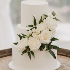 a white wedding cake with flowers on top