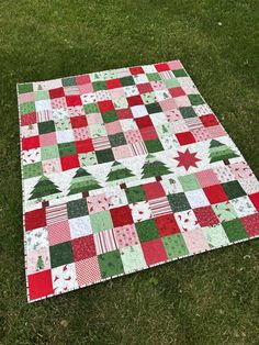 a patchwork christmas quilt on the grass