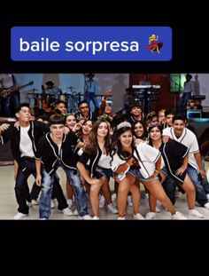 a group of young people posing for a photo in front of a microphone with the words baile sorpresa on it