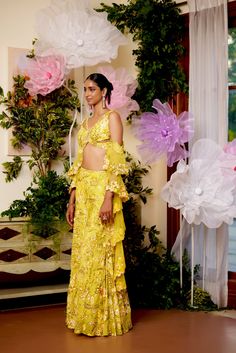 Like walking in a field of flowers where all the flowers bloom under the sun. The energy this co-ord set radiates is incomparable. The joy and comfort of the sun are presented in this set with utter glamour. The flared pants and a top in the shape of a butterfly are paired with a ruffle-sleeved dupatta which ties in the glamour and youth of the dress. The sleeveless blouse comes with drop-down ruffled sleeves along with a criss-cross pattern at the back. Hook at the back of the blouse. Sharara p Fitted Sets For Garden Party, Festive Summer Matching Palazzo Set, Festive Spring Sets With Floral Print, Summer Wedding Matching Set, Spring Wedding Matching Sets, Bohemian Sets With Floral Embroidery For Summer, Fitted Summer Sets With Floral Embroidery, Summer Party Palazzo Set With Floral Print, Summer Floral Print Palazzo Set For Parties