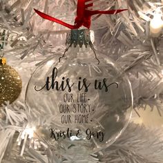 an ornament hanging from a christmas tree that says, this is us our life our story our home