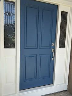 a blue front door with two sidelights and glass panels on the top half of it