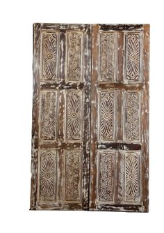 an old wooden door with decorative designs on it