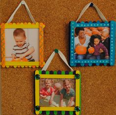 three frames hanging on a cork board with two children's pictures attached to them