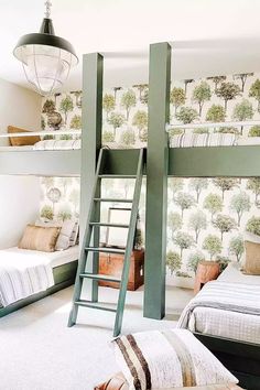 a bedroom with two bunk beds and a ladder