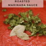 a red sauce with parsley on it and a sign that says roasted marinara sauce