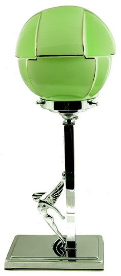 a green glass ball sitting on top of a metal stand