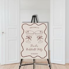 a welcome sign is on an easel in front of the door to a room