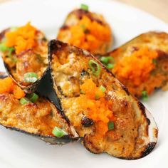 cooked eggplant and carrots on a white plate with green garnish