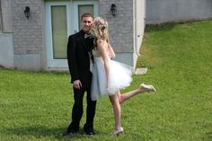 a man in a tuxedo standing next to a woman in a white dress