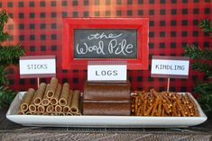 this is an image of a table with food and signs for the woodside party