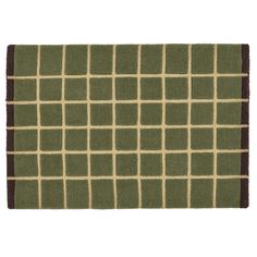 a green and brown rug with squares on it