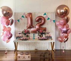 a table topped with lots of balloons next to a sign that says 21st on it