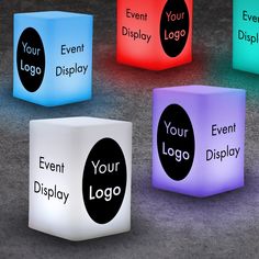 four illuminated cubes with the words your logo printed on them, all in different colors