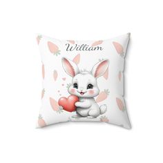 a white pillow with an image of a bunny holding a heart