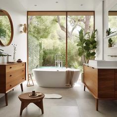 a bathroom with an oval tub and wooden cabinets