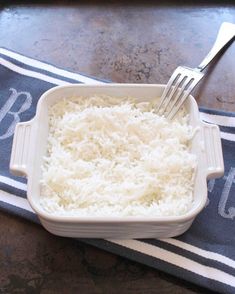 rice in a white dish with a fork