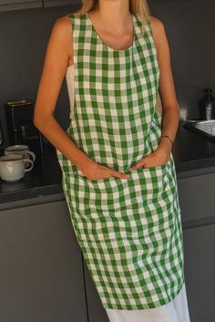 a woman in a green and white checkered apron