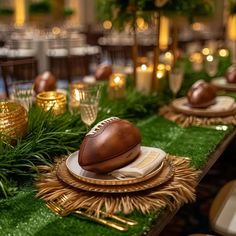 a table topped with plates covered in green grass and gold chargers on top of it