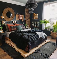 a bedroom with black walls and wooden flooring