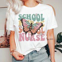 a woman with blonde hair wearing a white t - shirt that says school nurse on it