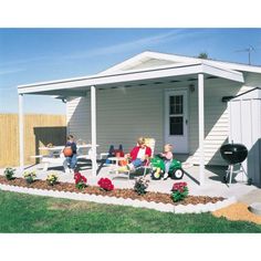 people sitting on lawn chairs in front of a small white house with a bbq