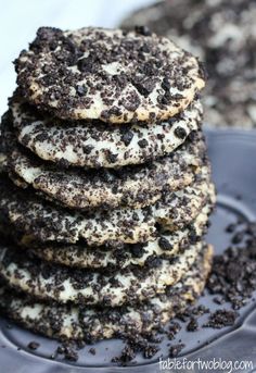 a stack of cookies sitting on top of a plate covered in oreo cookie crumbs