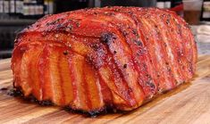 a large piece of meat sitting on top of a wooden cutting board