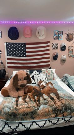 a bed room with a large american flag on the wall and a dog laying on it