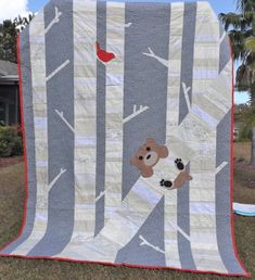 a teddy bear is on the tree quilt