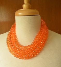 A beaded statement necklace made with translucent faceted orange lucite beads. - Shortest strand measures 18.5-20.5" long- 6 Strands - more are listed - Beads measure 10mm- Stainless Steel lobster claw (sterling silver, gold stainless steel, gold filled also available) - Stainless steel 2" extender chain- Lead free pewter connector The necklace length and number of strands can be customized. The mannequin's neck size is 14.5" for your reference. Larger quantities are available. Please let us kno Orange Statement Necklace, Acrylic Necklace, Silver Jewelry Box, Necklace Chunky, Beaded Statement Necklace, Multi Strand Necklace, Strand Necklace, Multi Strand, Necklace Length