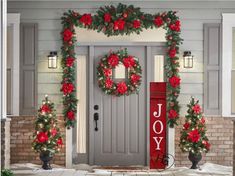 christmas wreaths and poinsettias are hanging on the front door