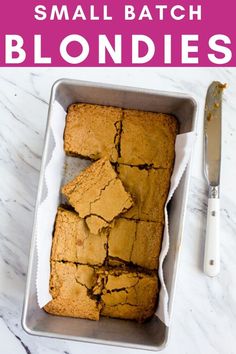 small batch blondies in a metal pan next to a knife and fork