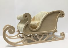 a wooden toy sleigh sitting on top of a table