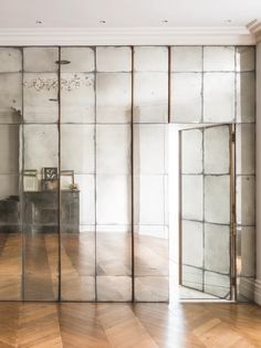 an empty room with mirrored walls and wooden floors