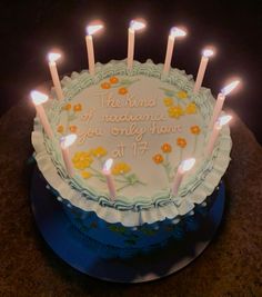 a birthday cake with lit candles on it