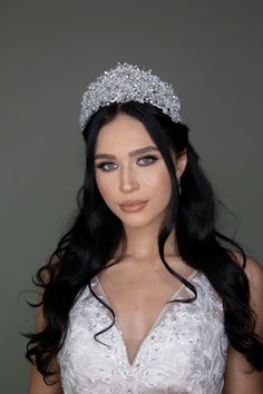 a woman with long hair wearing a tiara