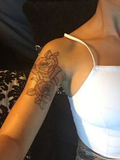 a woman with a flower tattoo on her arm