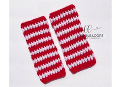 two red and white crocheted mitts on a white background