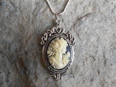 For sale are beautiful flawless (victorian woman with butterfly) cameo pendant necklaces!!!! Gorgeous!!! They are offered at a reasonable price, make perfect gifts, and are wonderful quality!!!!  The cameo is set in an ornate tibetan silver setting, and the chain is 22" .925 silver plated 1.2mm snake chain, with a lobster claw clasp!!!!  I make several varieties, colors, styles and matching sets!!!!  I will be glad to do special requests or matching pendant, cuff bracelet and/or brooch if you do Antique Silver Victorian Necklace, Woman With Butterfly, Cameo Pendant Necklace, Cameo Jewelry, Victorian Women, Cameo Pendant, Traditional Jewelry, Lovely Jewellery, Snake Chain