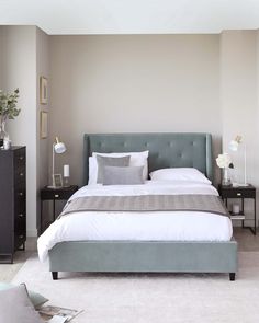 a bedroom with a bed, nightstands and two night stands