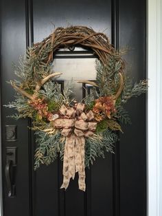 a wreath is hanging on the front door