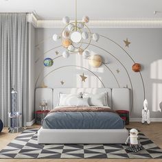 a bedroom decorated in white and gold with planets on the wall