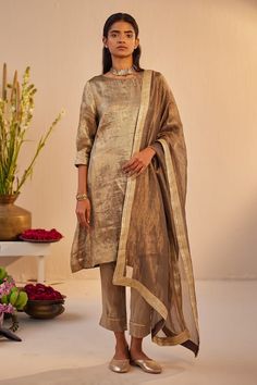 Grey-gold kurta in tissue brocade base with hand embroidery on neck. Comes with champagne grey cigarette pant. - Aza Fashions Gold Palazzo Set With Zari Work Traditional Drape, Gold Palazzo Set With Zari Work For Formal Occasions, Gold Palazzo Set With Zari Work For Formal Events, Formal Gold Palazzo Set With Zari Work, Gold Sharara For Formal Festive Occasions, Gold Formal Sharara For Festive Occasions, Festive Gold Sharara For Formal Occasions, Gold Kurta With Dupatta For Reception, Elegant Raw Silk Sets With Gold Embroidery