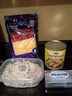 some food is sitting on a counter top next to a bag of cheese and an empty container