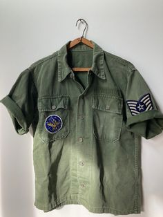 True vintage 1960's OG-107 Transitional shirt w/13 Star Metal buttons. Chopped to short sleeve, nice hand stitch hem. Excellent vintage condition, killer boxy fit with a couple nice patches. PTP 21", length 24.5", sleeve 10"  No refunds, returns or exchanges. You have options in shipping. We will not ship by surface mail outside N. America. Star Buttons, Dressup Party, Hand Stitch, Classic Dress, Metal Buttons, Vintage 1960s, True Vintage, Chopper, Hand Stitching