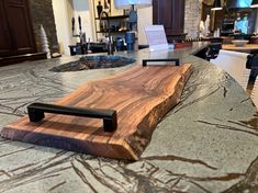 a wooden cutting board sitting on top of a kitchen counter